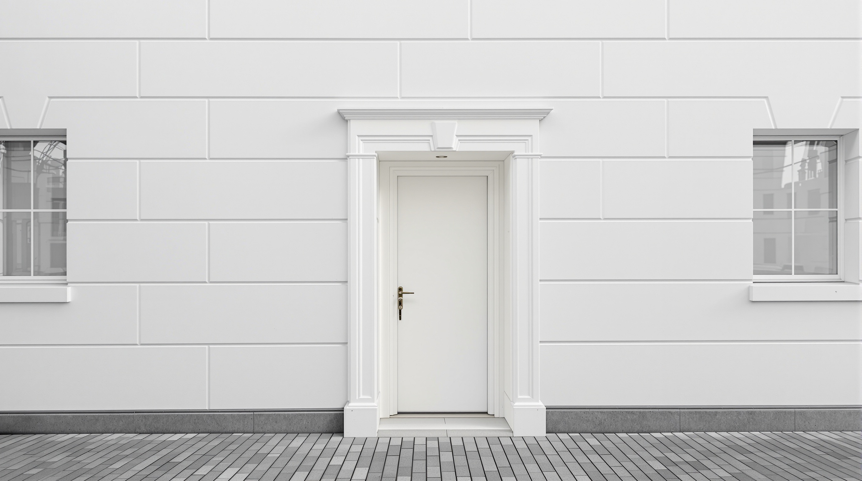 Porte d'entrée design fondue dans une façade uniforme et terne